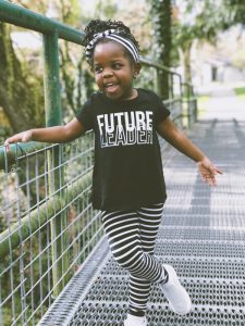 girl standing stylishly on a walk-through bridge